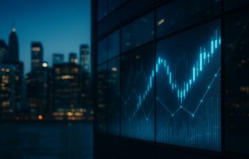 夜の金融街で、ガラス張りの高層ビルに発光する株価チャートが映し出されている様子